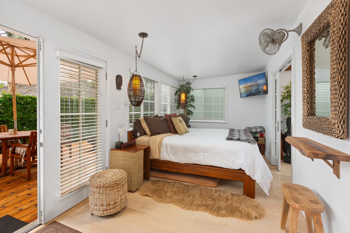Master bedroom with king bed and tropical decor